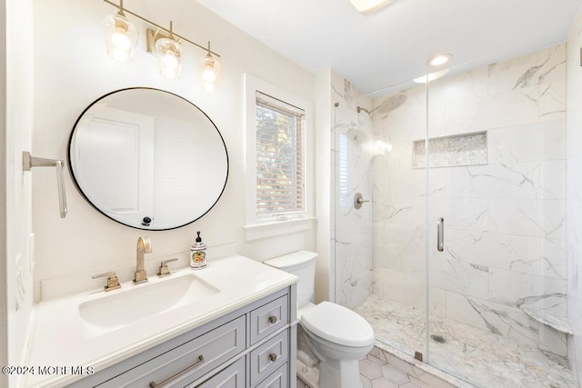 full bathroom featuring vanity, toilet, and a marble finish shower