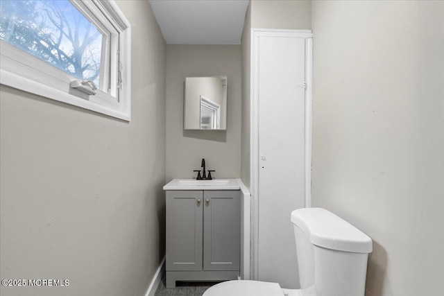 bathroom featuring toilet and vanity