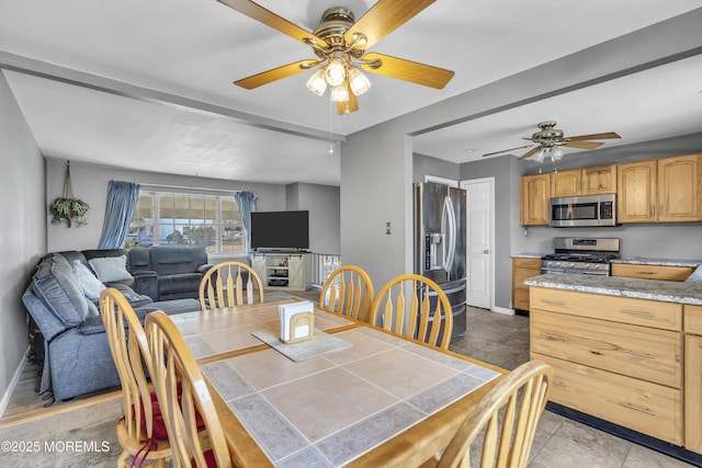 dining space featuring a ceiling fan and baseboards