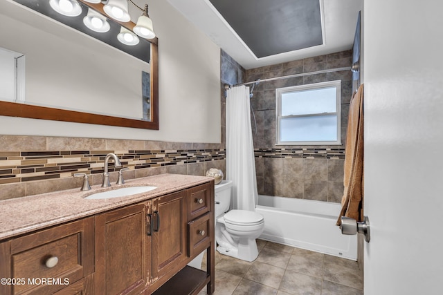 full bathroom with toilet, tile patterned flooring, tile walls, shower / bath combination with curtain, and vanity