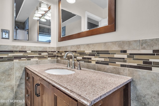 bathroom with wainscoting, tile walls, and vanity