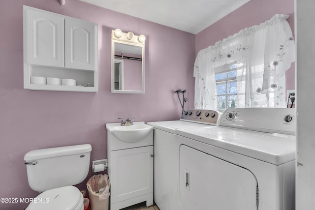 laundry room with laundry area, independent washer and dryer, and a sink