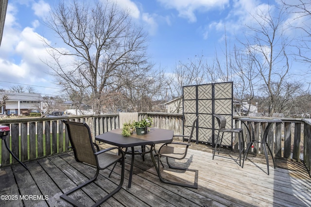 wooden terrace featuring outdoor dining space