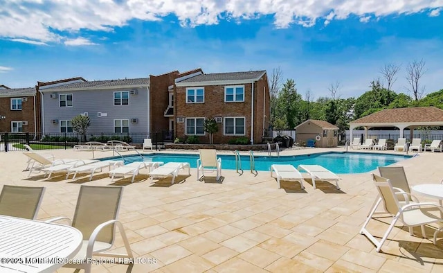 pool featuring a patio area and fence