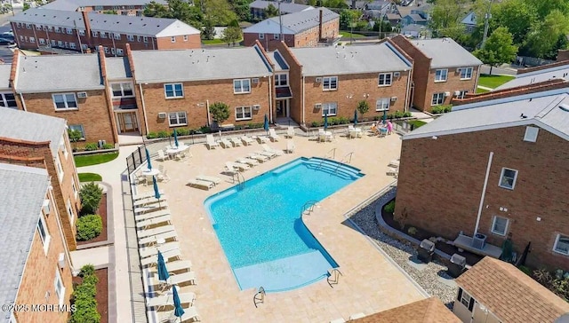 pool with a patio area and a residential view