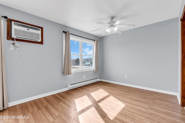 spare room with a ceiling fan, a wall mounted AC, a baseboard heating unit, light wood-style floors, and baseboards