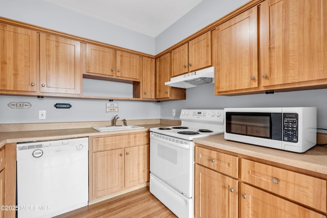 kitchen featuring under cabinet range hood, a sink, white appliances, light wood-style floors, and light countertops