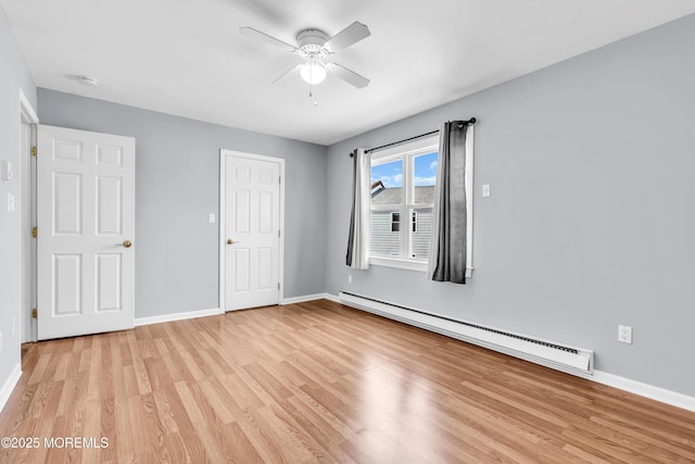 unfurnished bedroom with light wood-type flooring, a baseboard radiator, baseboards, and a ceiling fan