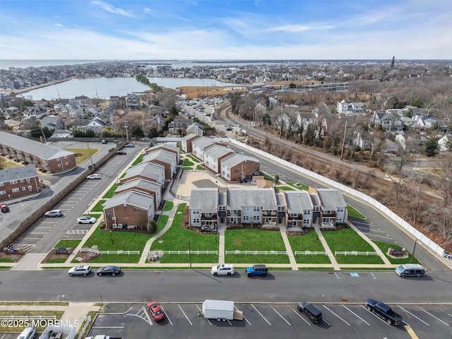 birds eye view of property featuring a water view and a residential view