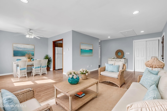 living area with recessed lighting, ceiling fan, baseboards, and wood finished floors