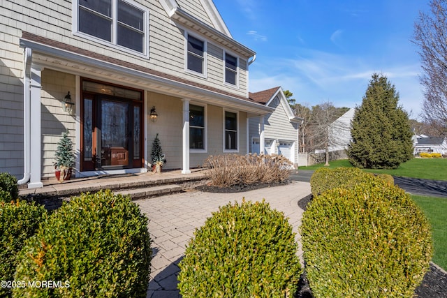 view of exterior entry with covered porch