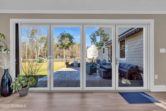 doorway with a healthy amount of sunlight and wood finished floors