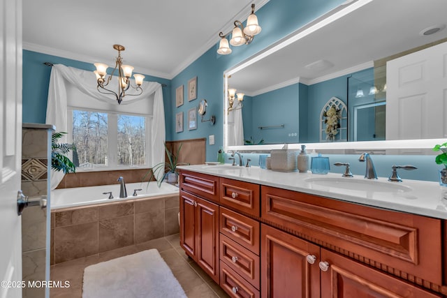 bathroom with a sink, an inviting chandelier, ornamental molding, and tile patterned floors