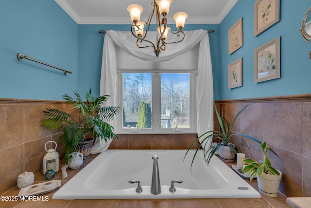 bathroom featuring crown molding, a bath, and a chandelier