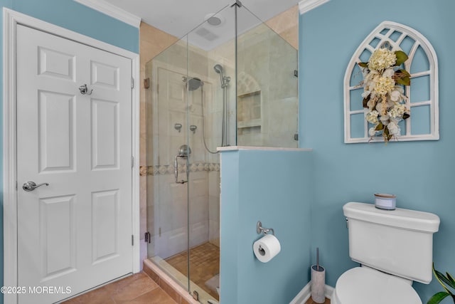 bathroom with tile patterned flooring, toilet, and a stall shower