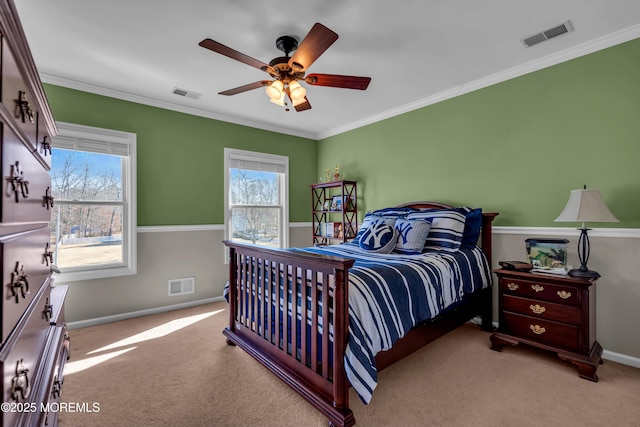 carpeted bedroom featuring visible vents, baseboards, and ornamental molding