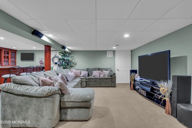 carpeted living room featuring recessed lighting, visible vents, indoor bar, and a drop ceiling