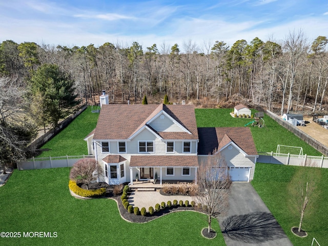 drone / aerial view featuring a wooded view