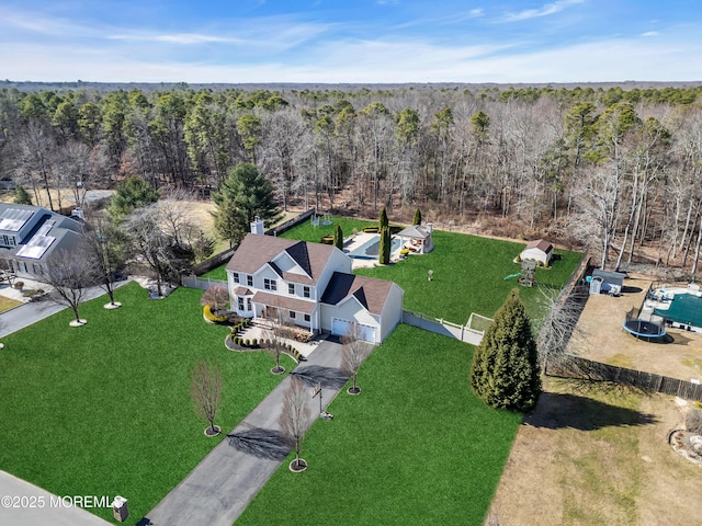 drone / aerial view featuring a view of trees