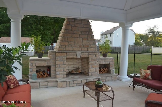 view of patio with an outdoor living space with a fireplace and fence