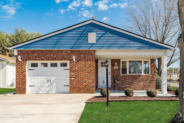 view of front facade with concrete driveway, a garage, brick siding, and a front yard