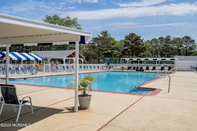 pool with a patio and fence