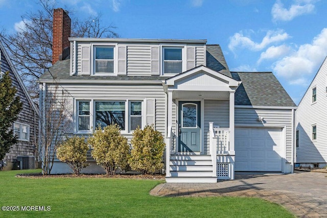 traditional-style home featuring driveway, central AC, a chimney, a front lawn, and a garage