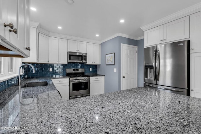 kitchen featuring backsplash, ornamental molding, stone countertops, stainless steel appliances, and a sink