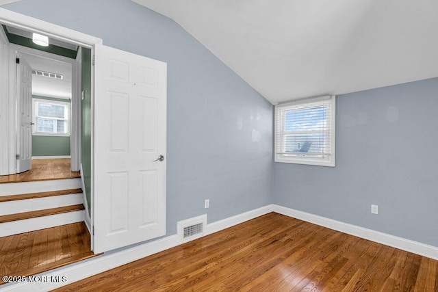 interior space with visible vents, baseboards, and wood finished floors