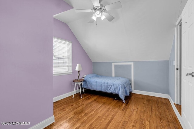 bedroom with lofted ceiling, a ceiling fan, baseboards, and light wood finished floors