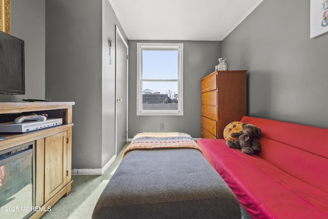 bedroom featuring light colored carpet and baseboards