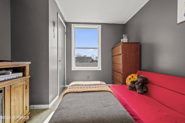 bedroom featuring baseboards and carpet