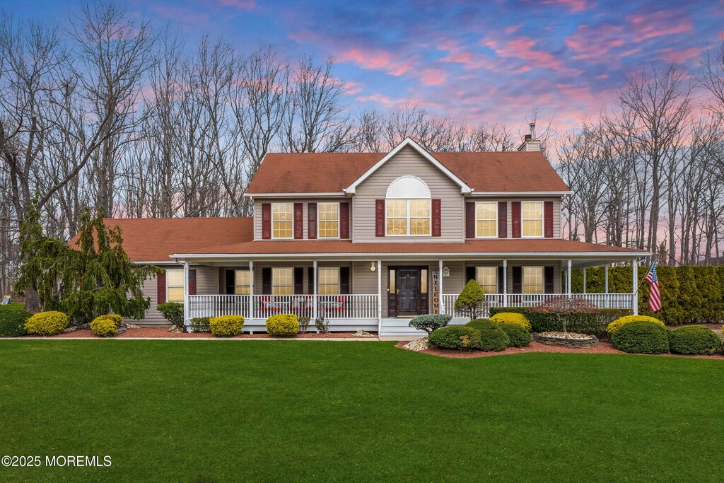 4 Carroll Ct, Jackson, NJ 08527 - view of front facade with a lawn, a chimney, and covered porch