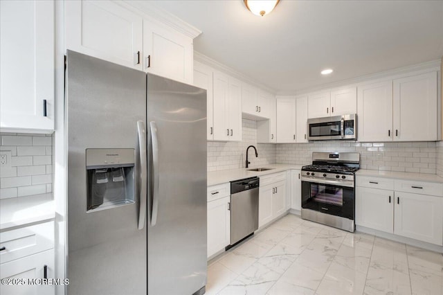 kitchen featuring marble finish floor, a sink, white cabinetry, stainless steel appliances, and light countertops