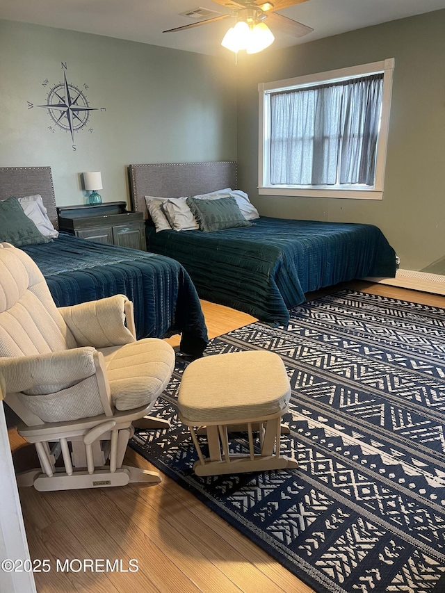 bedroom with wood finished floors and ceiling fan