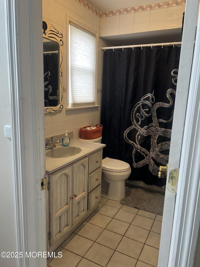 bathroom with tile patterned floors, toilet, tile walls, decorative backsplash, and vanity