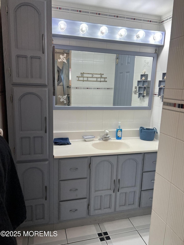 bathroom with tile patterned flooring, vanity, and tile walls