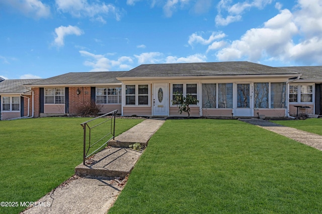 ranch-style home with brick siding and a front lawn