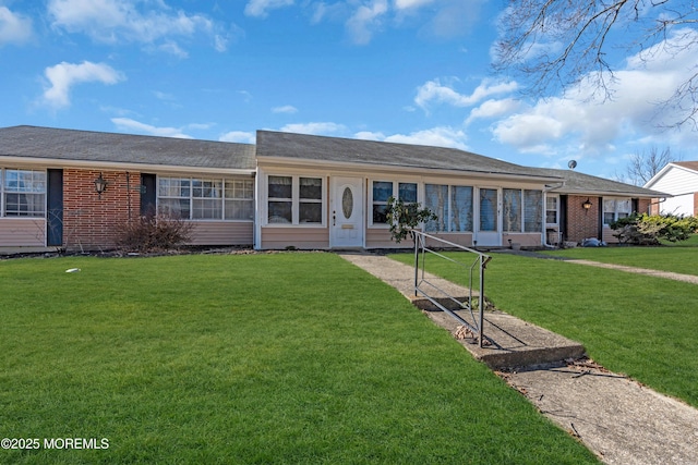 ranch-style house with a front lawn and brick siding