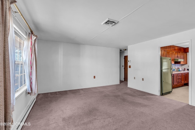 unfurnished living room featuring visible vents, light colored carpet, and a baseboard radiator