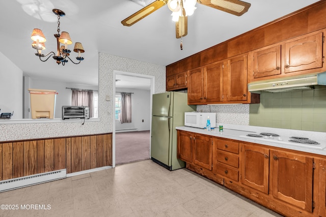 kitchen featuring white appliances, light floors, light countertops, under cabinet range hood, and wainscoting