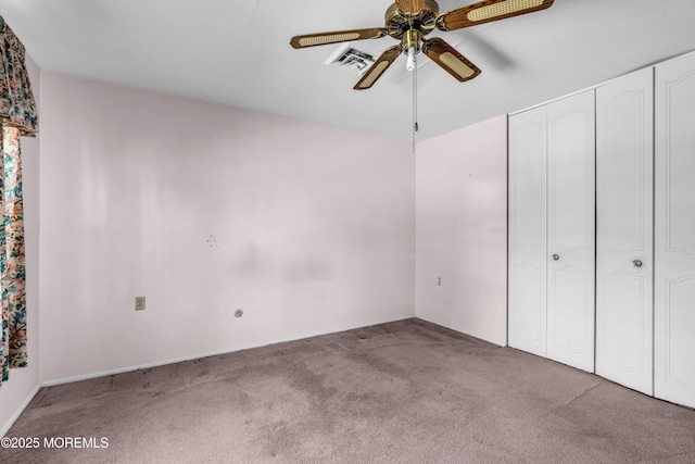 unfurnished bedroom with a ceiling fan, carpet flooring, visible vents, and a closet