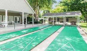 view of home's community featuring shuffleboard