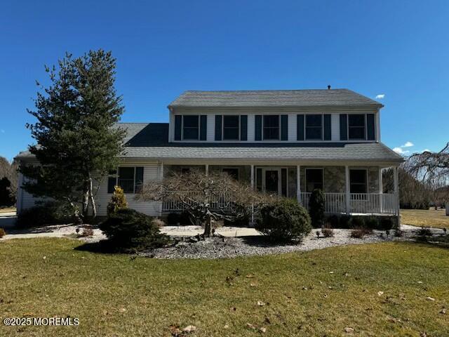 view of front of house with covered porch and a front yard