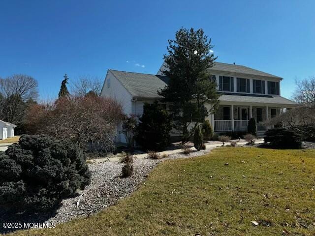 view of front of house featuring a front lawn and a porch