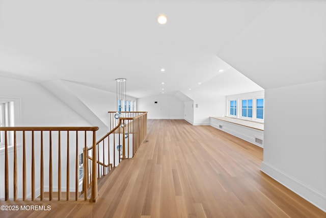 additional living space featuring visible vents, recessed lighting, baseboards, light wood-style floors, and lofted ceiling