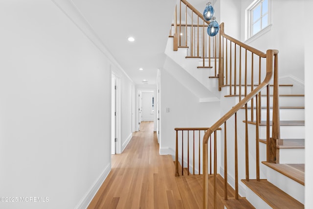 staircase with recessed lighting, baseboards, and wood finished floors