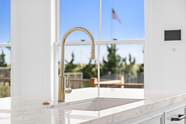 room details with a sink and light stone counters