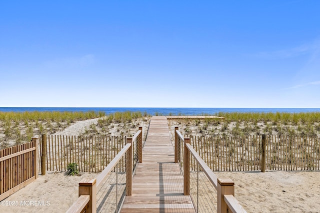 view of home's community with a beach view and a water view