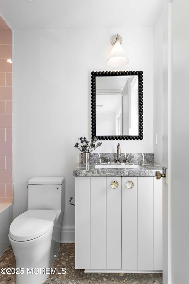 bathroom with toilet and vanity